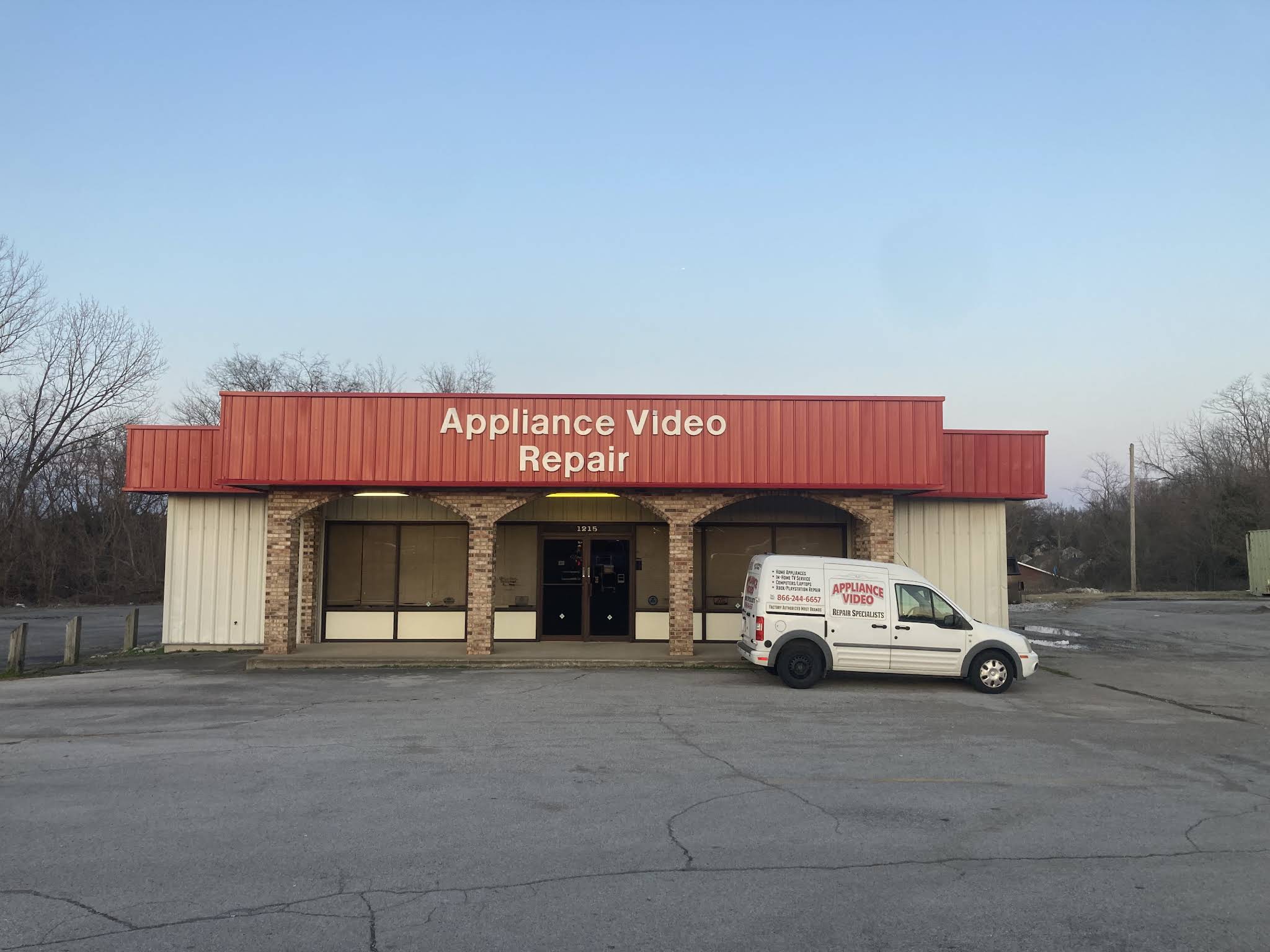A V Repair Specialists storefront with its red Appliance Video Repair sign and service van in Clarksville